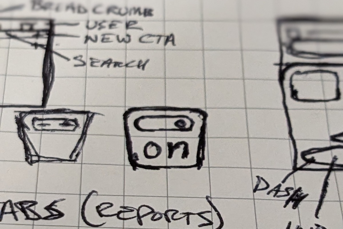 A pen sketch on graph paper of a tapered tote with an on switch for a handle and the letters on, next to notes for the dashboard header